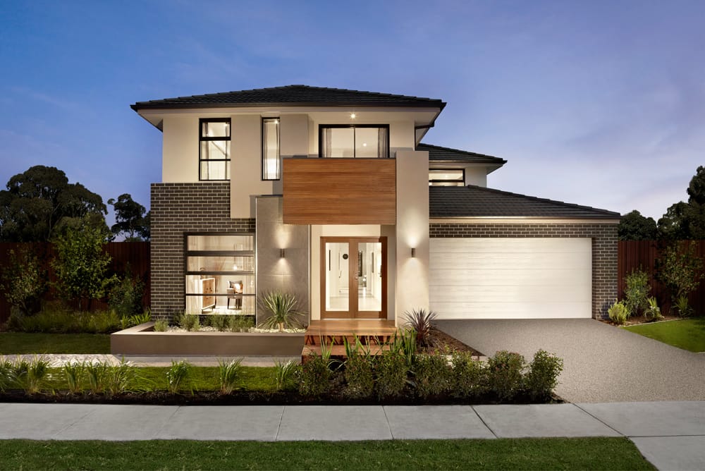 Steel-Line sectional garage door in white on a double storey home at dusk