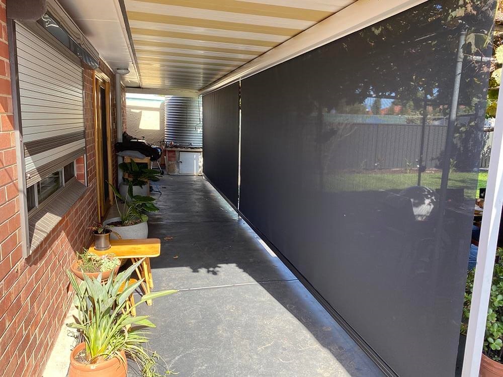 Black Straight Drop Blinds by the lawn to keep your home insulated during the summer and winter. Perfect for those where tracked blinds cannot be used.